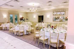 Conservatory Ballroom at Talamore Weddings with high ceilings, windows and chandeliers during a wedding reception