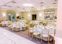 Conservatory Ballroom at Talamore Weddings with high ceilings, windows and chandeliers during a wedding reception
